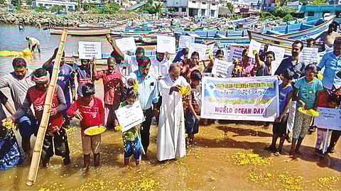 Fisherfolk drop petals into sea to mark World Oceans Day at Colachel coast in Kanniyakumari on Wednesday