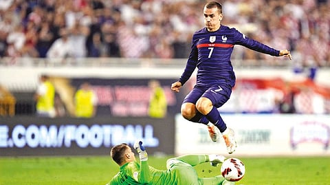 Croatia?s goalkeeper Dominik Livakovic makes a save in front of France?s Antoine Griezmann during the UEFA Nations League match