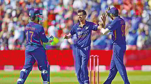 Yuzvendra Chahal is congratulated after taking the wicket of Dawid Malan