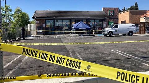 Police crime scene tape closes off a parking area