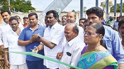 AIADMK Vellore urban district secretary SRK Appu cutting a ribbon to reopen Katpadi bridge in Vellore on Friday