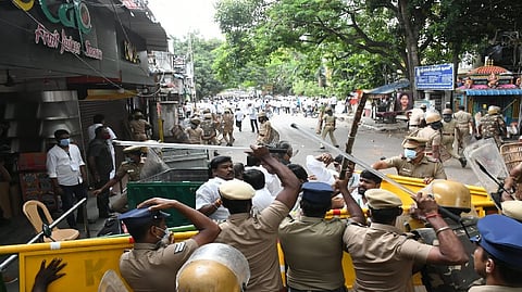 Cops chasing protesters who vandalised properties.