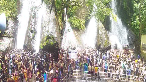 Tourists thronging the Five Falls at Courtallam on Sunday