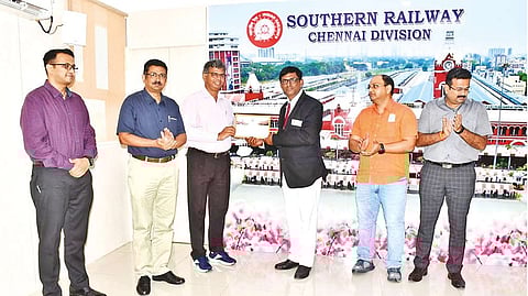 Troydon Scurville, TTE of Train 12658, being rewarded by officials of the Southern Railway