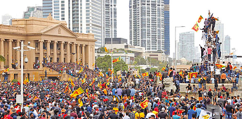 Protesters celebrate after entering the Presidential Secretariat