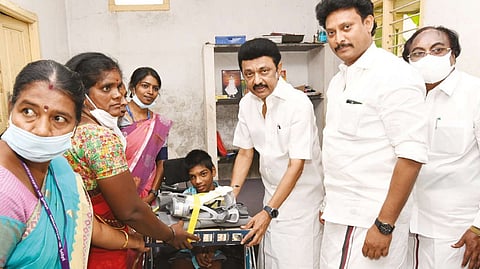 Chief Minister MK Stalin interacting with differently-abled Sivanandan (14) at his home in Tiruvannamalai district on Friday