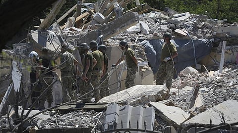 Ukrainian State Emergency Service firefighters work at damaged residential building