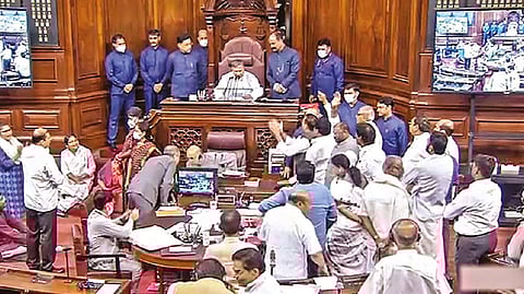 Opposition members protest in the Rajya Sabha during the ongoing Monsoon Session