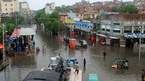 People navigate through flooded roads after heavy monsoon rains in Pakistan