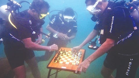 SB Aravind Tharunsri and his family playing chess under water