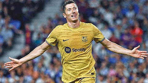 Robert Lewandowski celebrates after netting Barcelona?s third goal.