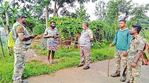Forest staff inquiring tribal residents during their search for the mother elephant in The Nilgiris on Wednesday