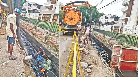 Workers removing sewage at Millers Road