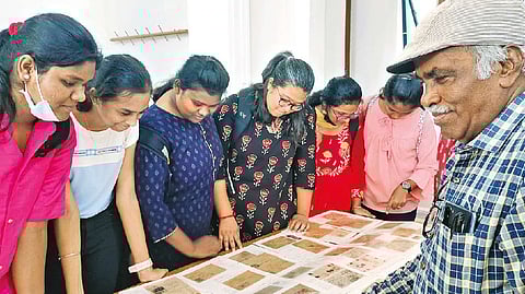 Rolands explaining his postcards to students.