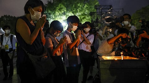 The Japanese people are saying prayer in remembrance of Hiroshima bombing victims