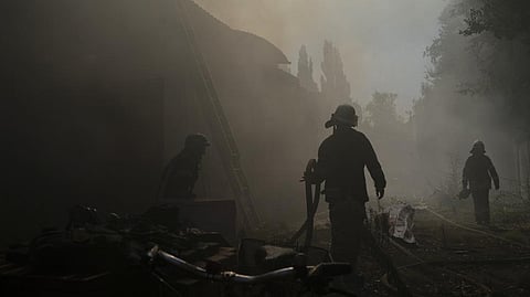 Firefighters work to extinguish a fire after a Russian attack that heavily damaged a building in Sloviansk.