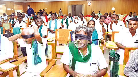 Farmers attend grievance day meeting blindfolded to protest Electricity Amendment Bill in Thanjavur on Friday.