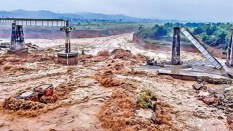 A portion of the railway bridge over the Chakki river that collapsed due to heavy floods in Dharamshala, Saturday.