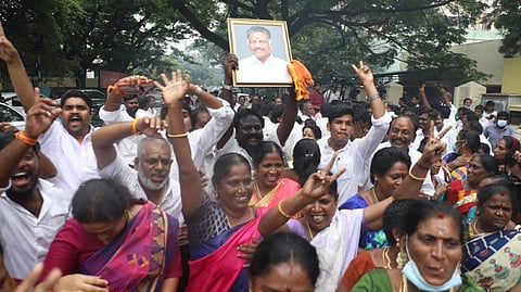 Supporters of OPS celebrate outside his residents after the HC verdict