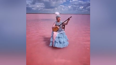 Woman playing music on salt lake