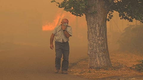 A resident flees from the flames in A?on de Moncayo
