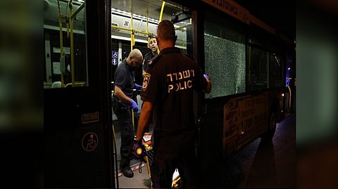 Officials examining the bus