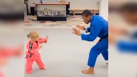 Adorable young girl beats karate trainer; internet calls it “cute"