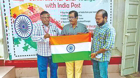Vellore HPO officials with philatelist C Tamilvanan unveiling the national flag for sale to public on Wednesday