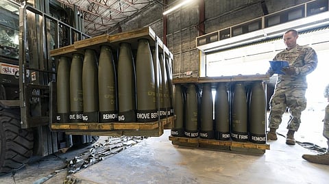 U.S. Air Force Staff checks pallets of 155 mm shells