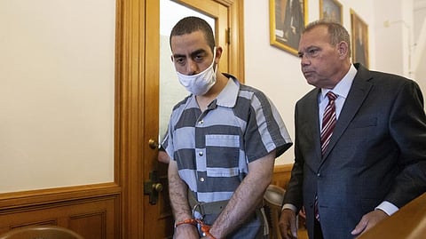 Hadi Matar, 24, left, and defense attorney Nathaniel Barone, right, talk after an arraignment in the Chautauqua County Courthouse in Mayville.