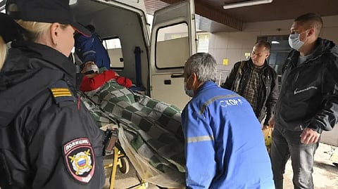 Medical staff carry an injured person into an ambulance at the emergency department of the First Republican Clinical hospital to evacuate to Russia.