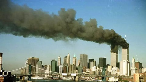 The towers of the World Trade Center pour smoke shortly after being struck by hijacked commercial aircraft.