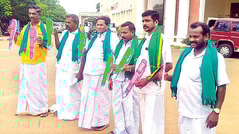 Farmers protest holding pen models objecting to a memorial to M Karunanidhi while seeking more godowns
