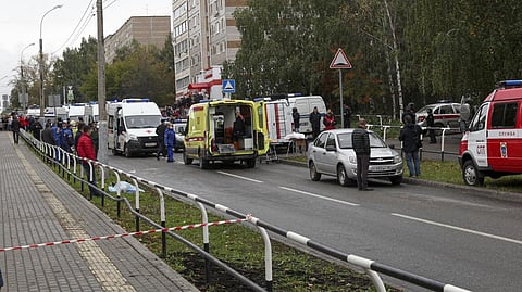 Police and paramedics work at the scene of a shooting at school No. 88 in Izhevsk, Russia, Monday, Sept. 26, 2022. A gunman on Monday morning killed 13 people and wounded 21 others in a school in central Russia, authorities said.