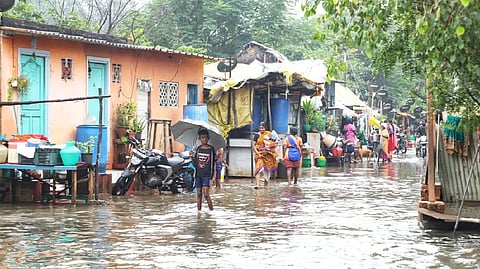 A boy walks on a marooned street in Chennai