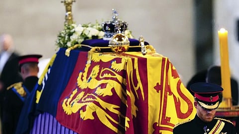 (L-R) Prince William, the prince of Wales and Prince Harry participate in the vigil of the Queen's grandchildren around the coffin, as it lies in state on the catafalque in Westminster Hall, at the Palace of Westminster, London.