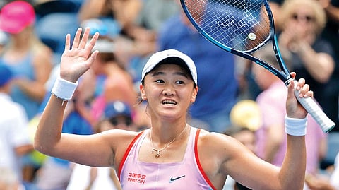 Wang Xiyu reacts after defeating Maria Sakkari