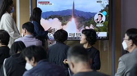 People watch a news program showing a file image of a missile launch by North Korea at the Seoul Railway Station