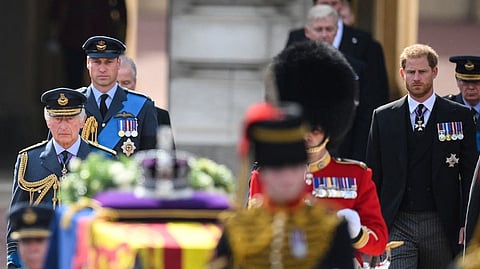 King Charles III, Prince William, Prince of Wales and Prince Harry, Duke of Sussex walk behind the coffin of Queen Elizabeth II