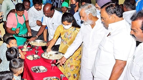 Minister Ma Subramanian and Mayor Priya Rajan serving food to the children