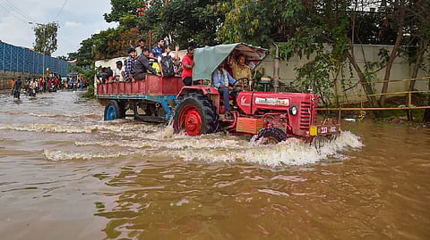A tractor being used to evacuate people stranded at the waterlogged Yemalur area after heavy monsoon rains, in Bengaluru,