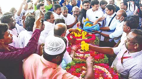 Ministers KN Nehru, KS Masthan and Mahesh Poyyamozhi paying tribute to Muthukumaran at Tiruchy airport on Friday.