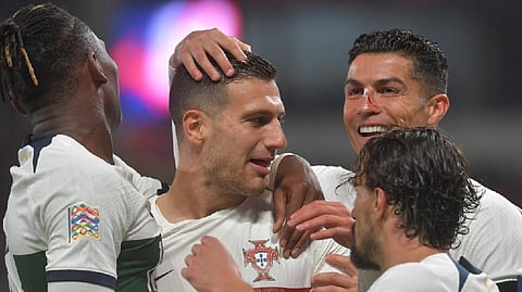 Portugal?s defender Diogo Dalot celebrates scoring his team?s third goal with his team mates during the UEFA Nations League