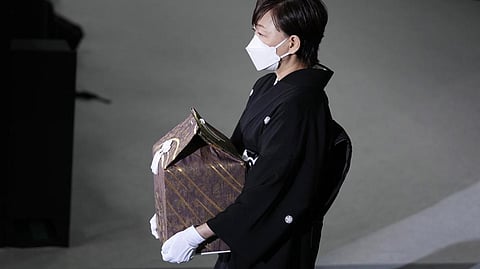 Akie Abe, wife of former Prime Minister Shinzo Abe, carries a cinerary urn containing his ashes at his state funeral