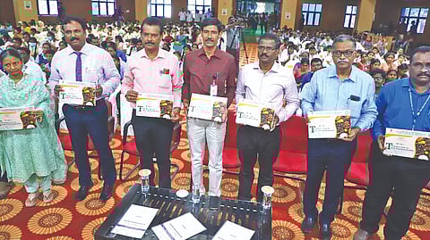 Dignitaries holding the booklet on millets released in Thanjavur on Friday.