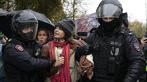 Police officers detain a demonstrator during a protest against a partial mobilization in Moscow, Russia, Saturday.