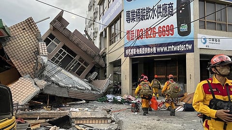 Firefighters in search for trapped victims in a collapsed residential building following earthquake in Yuli township in Taiwan