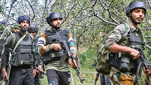 Security personnel during a Cordon and Search Operation after two migrant labourers were killed