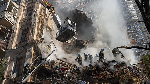 Firefighters work after a drone attack on buildings in Kyiv, Ukraine.