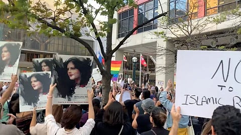 People attend a protest in solidarity with the women in Iran, following the death of Mahsa Amini